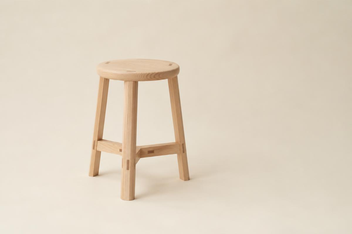 Minimal handmade ash stool with wedged through-tenons
